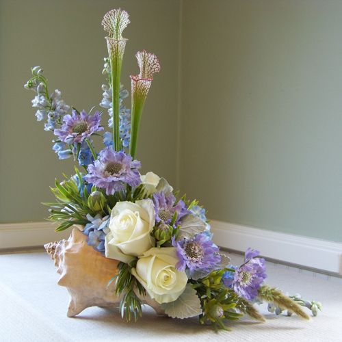 a bouquet of flowers sitting on top of a white floor next to a window sill