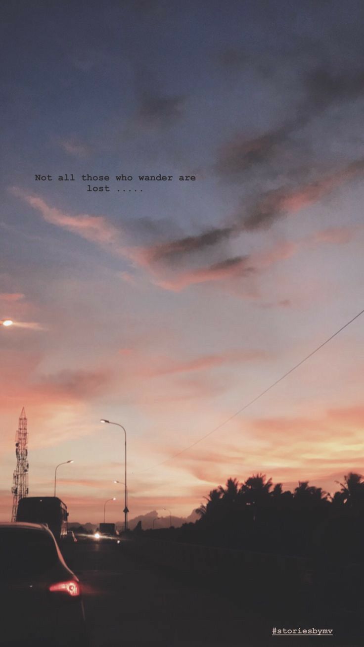 cars driving down the road at dusk with a quote above them that reads, not all those who wander are