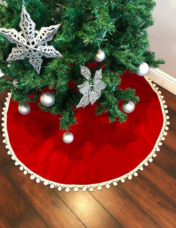 a christmas tree skirt with ornaments on it