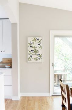 a dining room table and chairs in front of a sliding glass door that leads to a deck