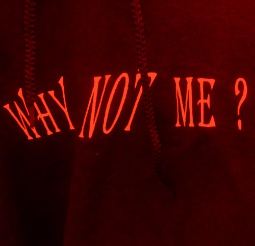 a red hoodie with the words, why not me? written on it's side