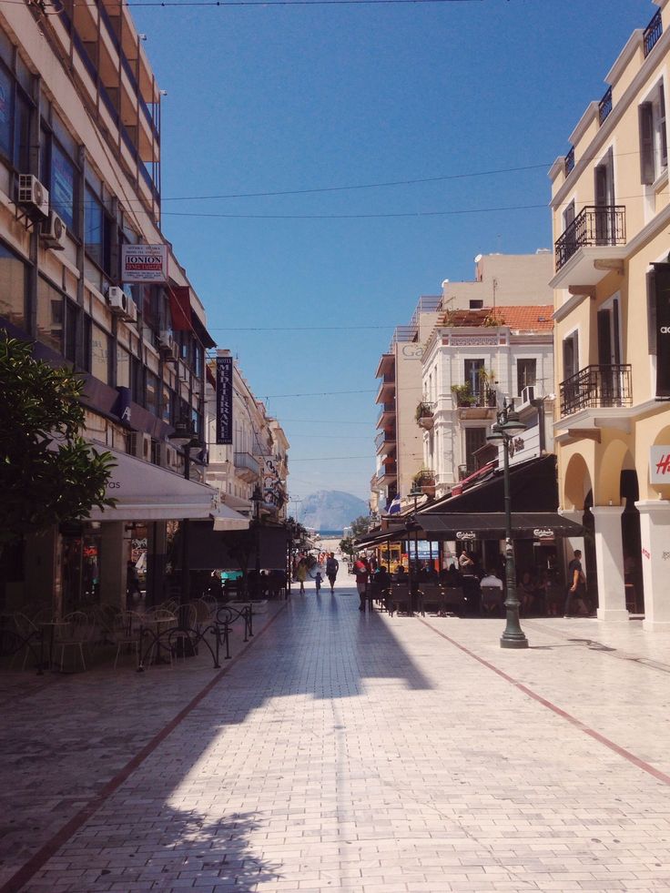 an empty city street with people walking on it