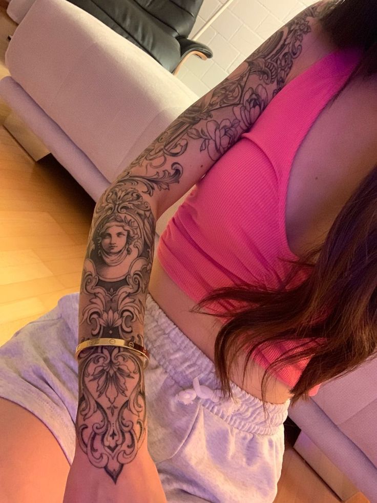 a woman with a tattoo on her arm