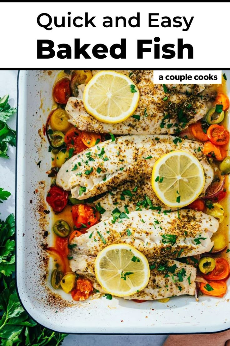 fish with lemons, tomatoes and peppers in a white casserole dish