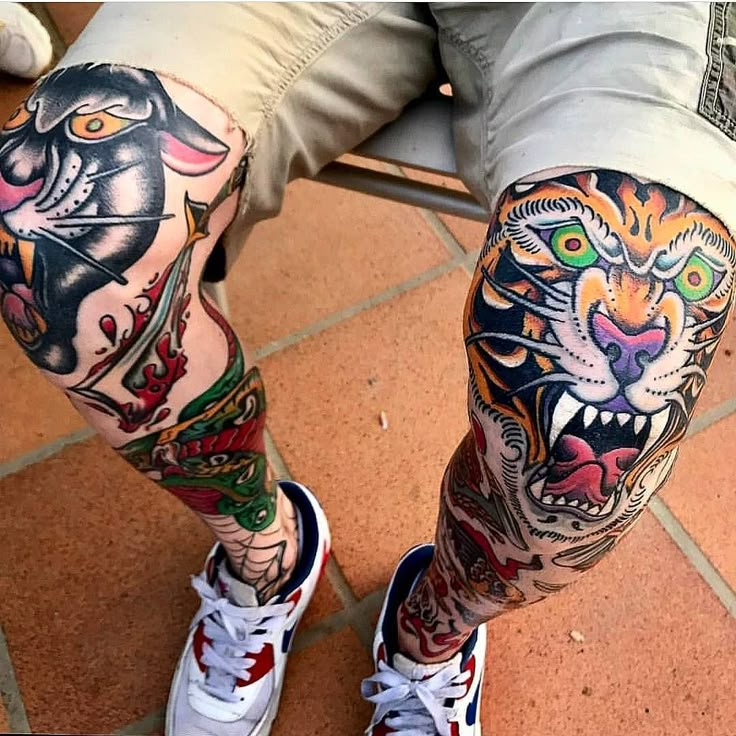 a man's legs with tattoos on them and an image of a tiger in the middle