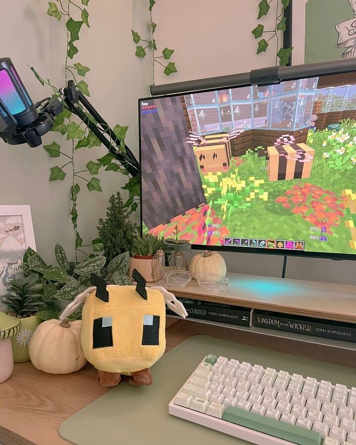 a computer monitor sitting on top of a desk next to a keyboard