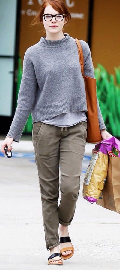 a woman walking down the street carrying shopping bags