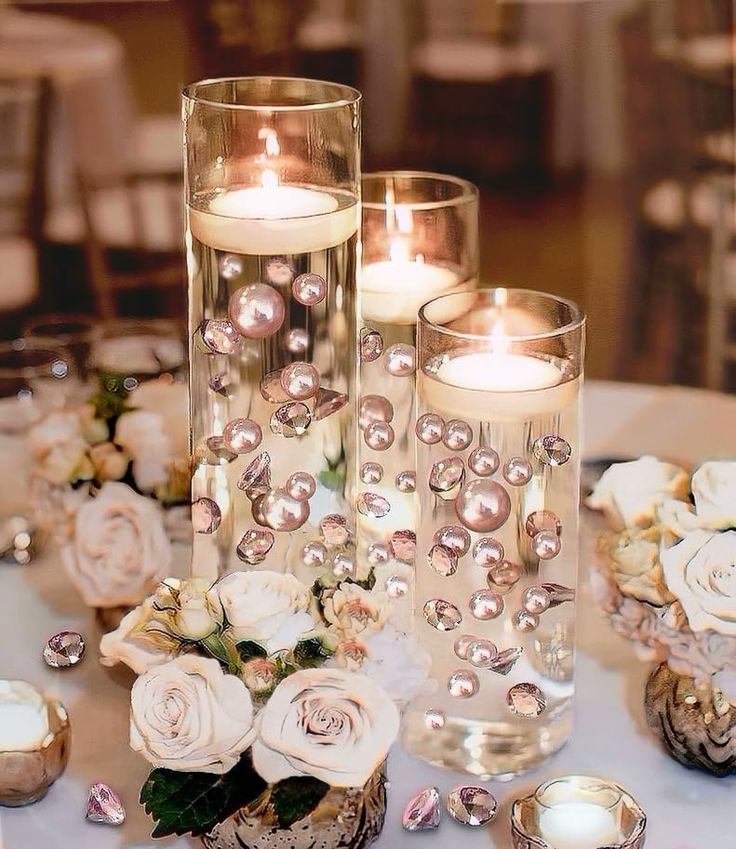 candles and flowers are sitting on a table