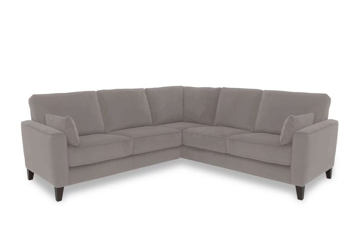 a gray sectional sofa with two pillows on it's back end and one arm facing the couch