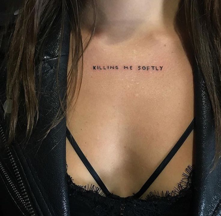 a woman's chest with the words killing me softly tattooed on her left side