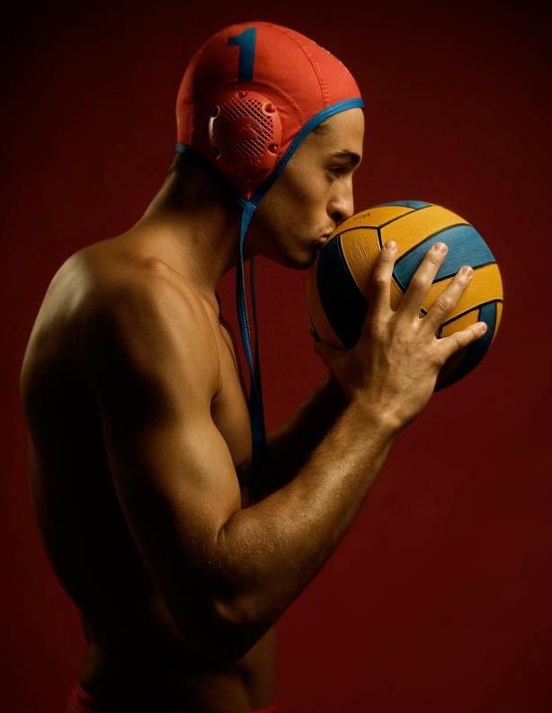 a shirtless man holding a basketball in his hands