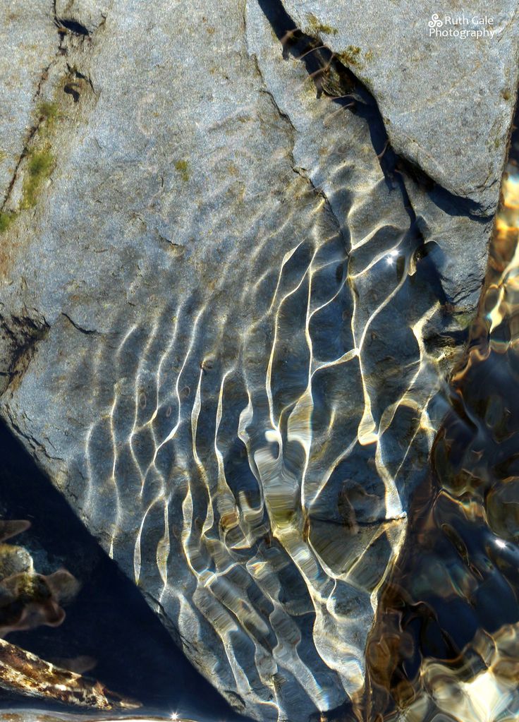 water flowing over rocks in the sun