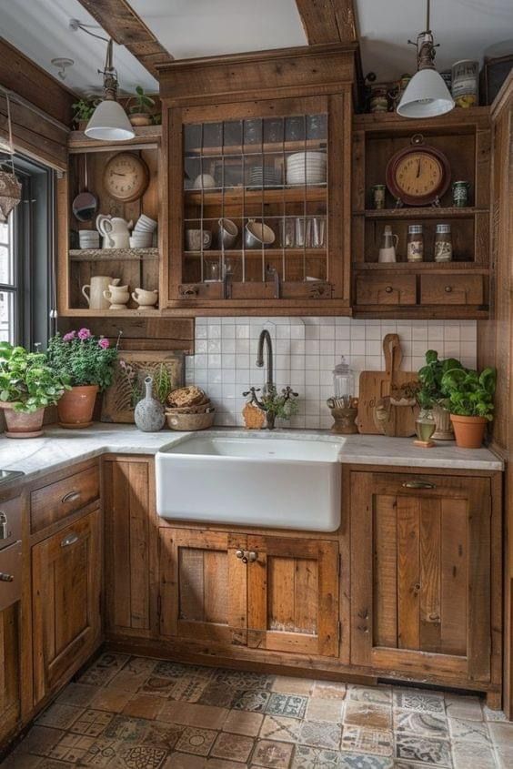 a kitchen filled with lots of wooden cabinets and counter top space next to a window