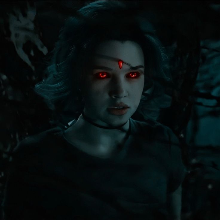 a woman with glowing red eyes in the dark forest, staring at something or someone