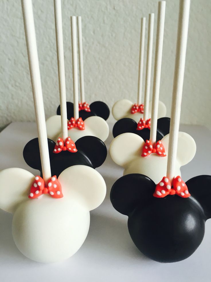 mickey mouse cake pops with red bows on them