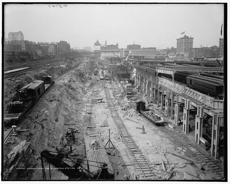 an old black and white photo of train tracks in the middle of a construction area