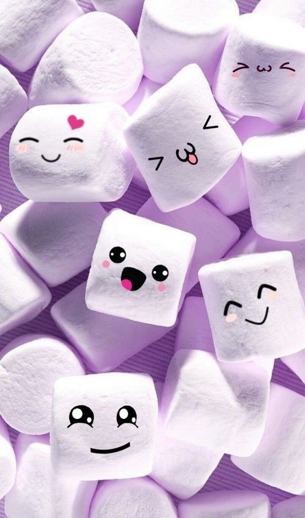 marshmallows with faces drawn on them are arranged in the shape of hearts