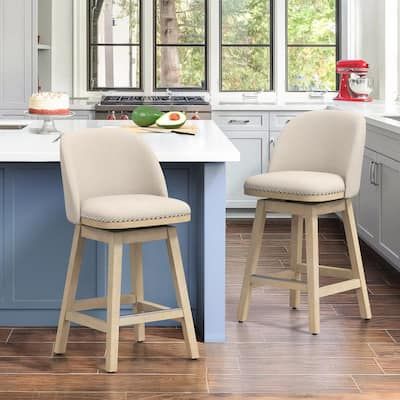 two stools sit at the center of a kitchen island with blue cabinets and white countertops