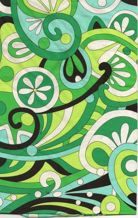 a green and black pattern with swirls on it