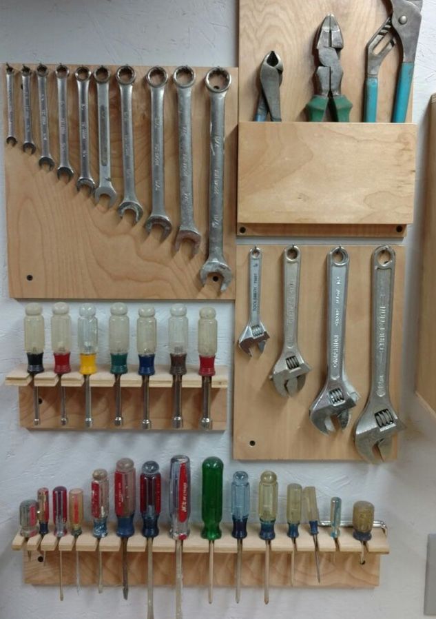 there are many tools hanging on the wall