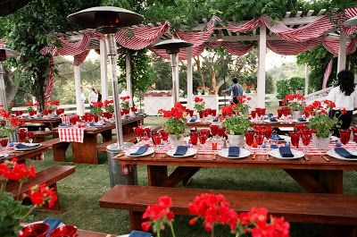 an outdoor picnic area with red, white and blue decorations