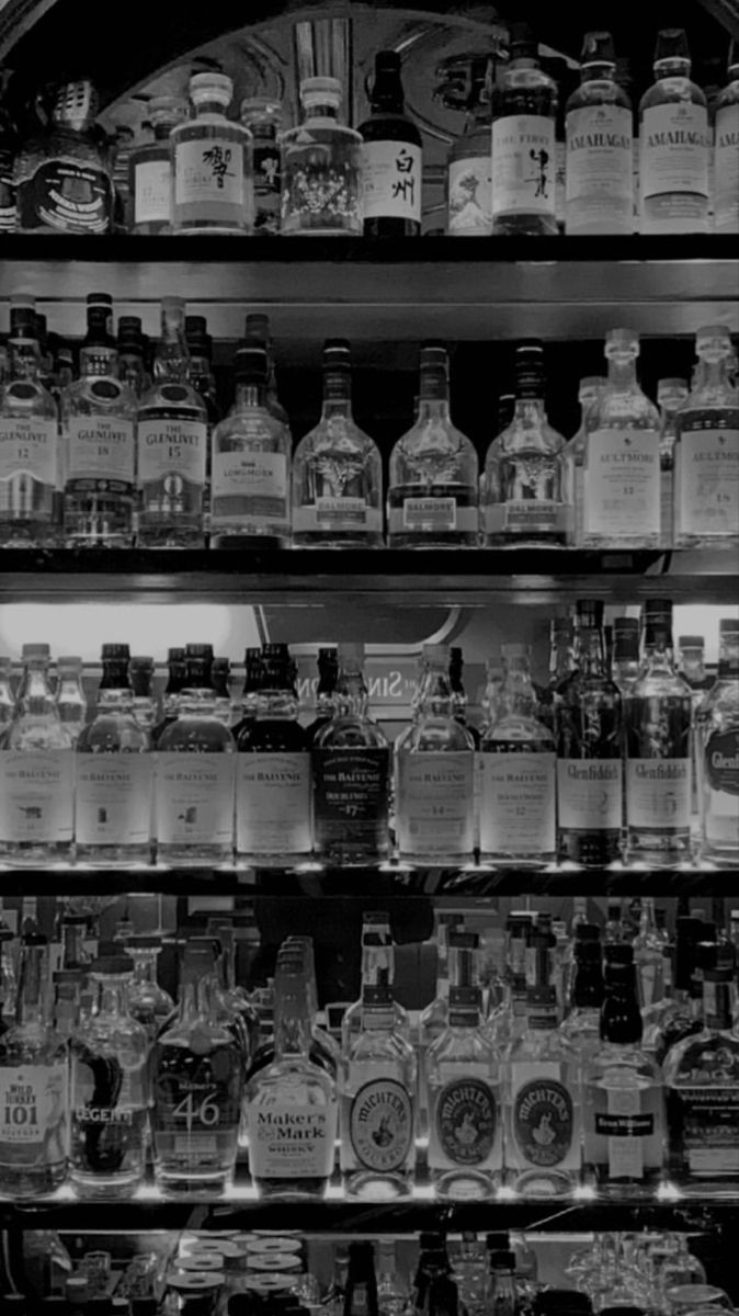 an assortment of liquor bottles on shelves in a store