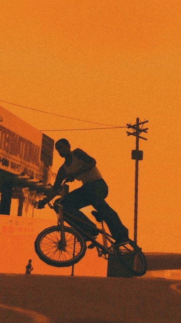 a man riding a bike down the side of a road