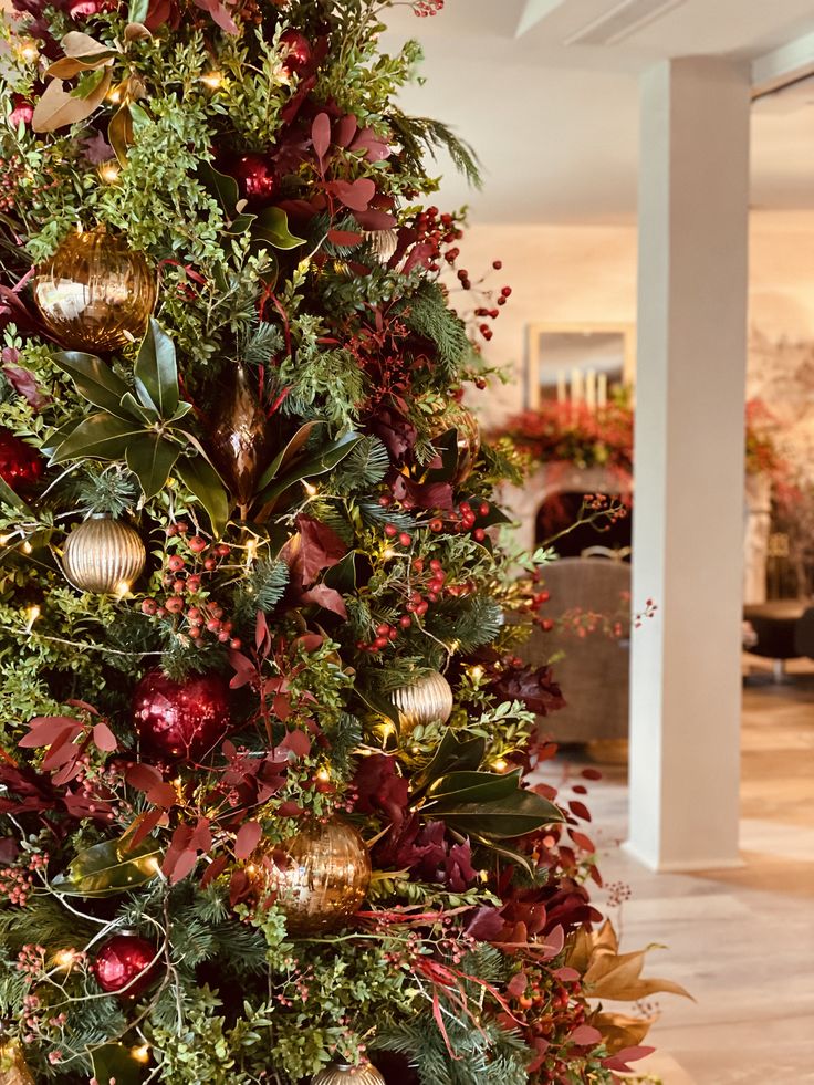 a christmas tree decorated with ornaments and greenery