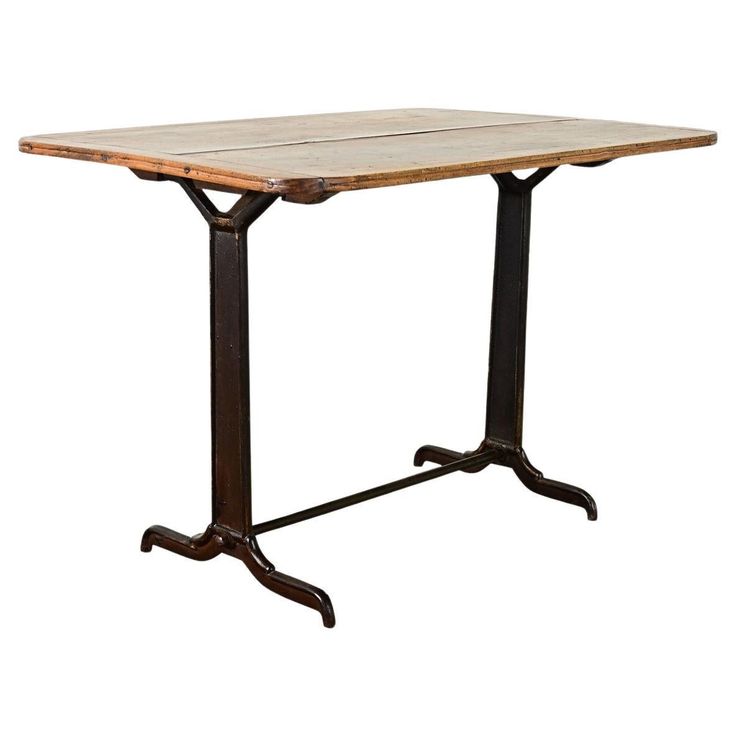 an old wooden table with metal legs and a square top, on a white background