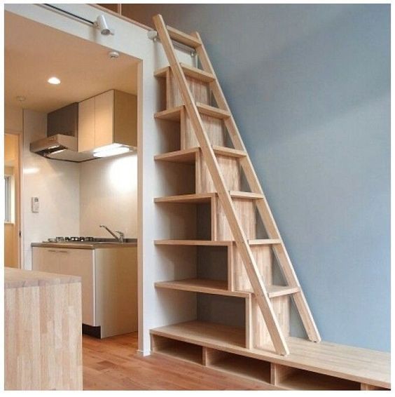 an open staircase leading to a kitchen and living room