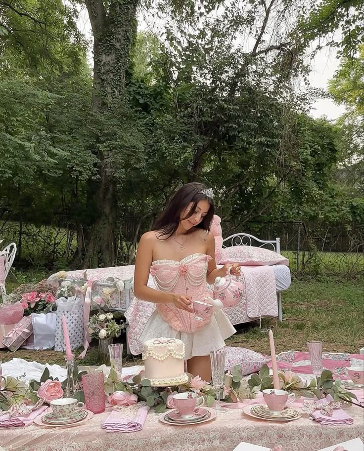 a woman standing in front of a table filled with cake