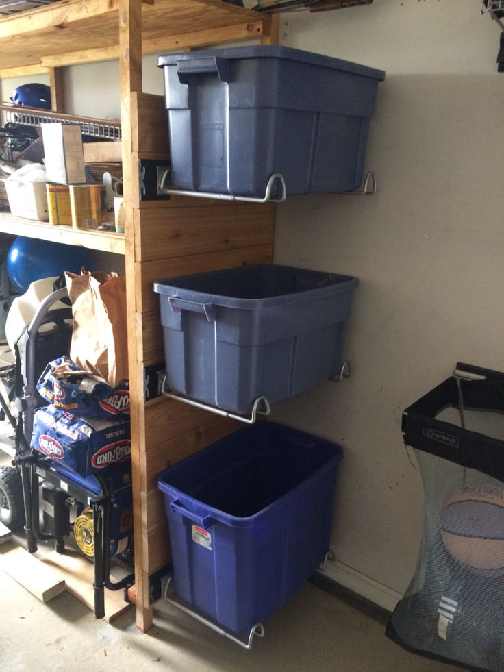 several bins are stacked on the shelves in this garage storage area, along with other items