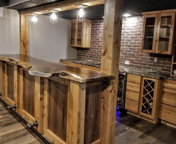 an empty kitchen with wooden cabinets and granite counter tops, along with exposed brick walls