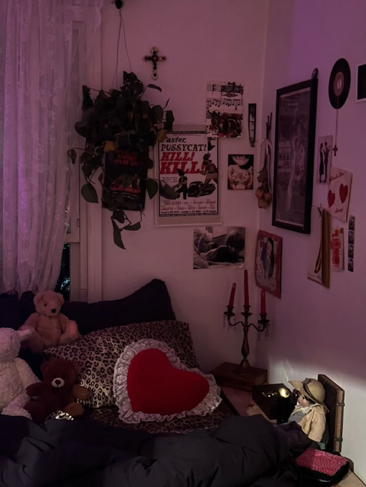 a bedroom with pink walls and lots of pictures on the wall, including teddy bears