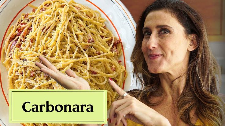 a woman pointing to a plate of spaghetti with the word carbonara in front of her