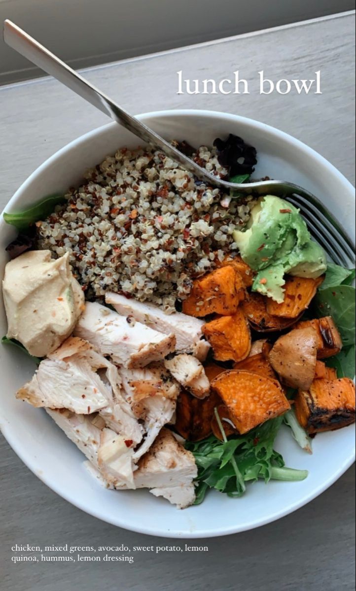 a white bowl filled with meat and vegetables