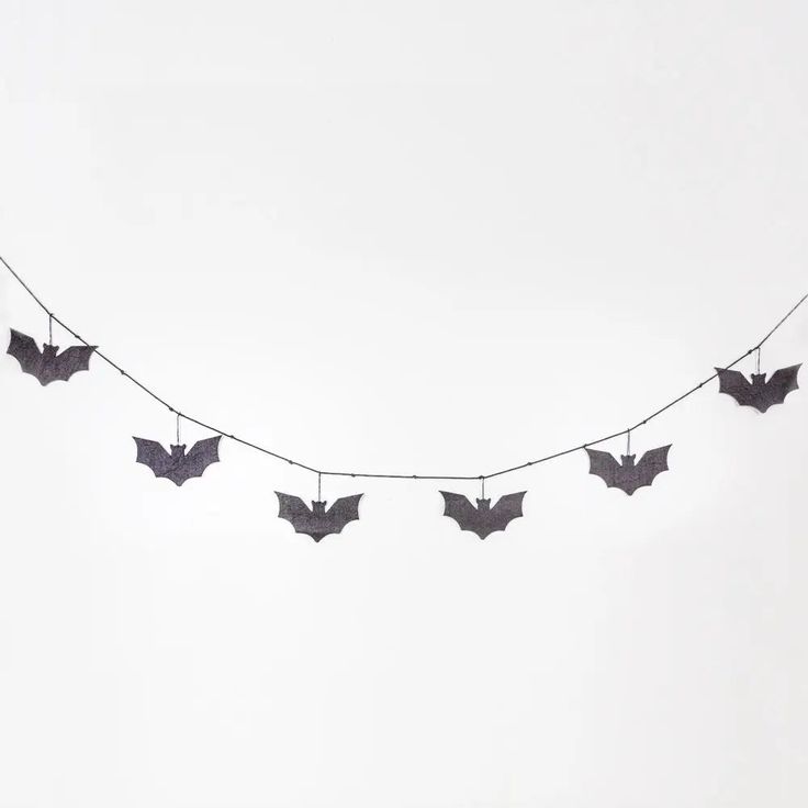 bats are hanging on a string in the sky