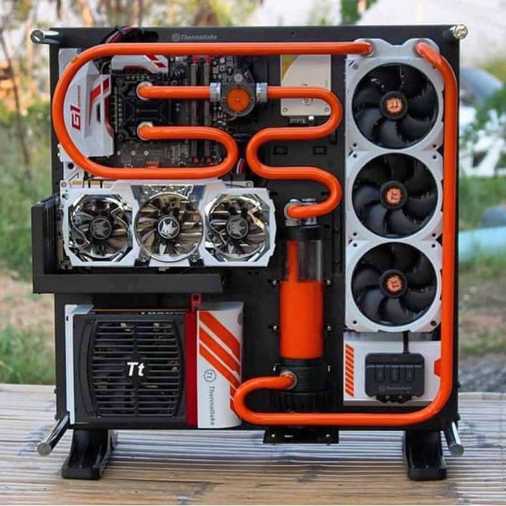 an orange and black computer case sitting on top of a wooden table