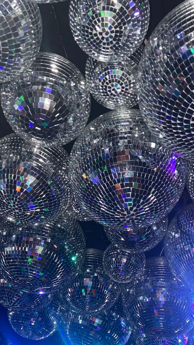 many shiny disco balls are stacked on top of each other