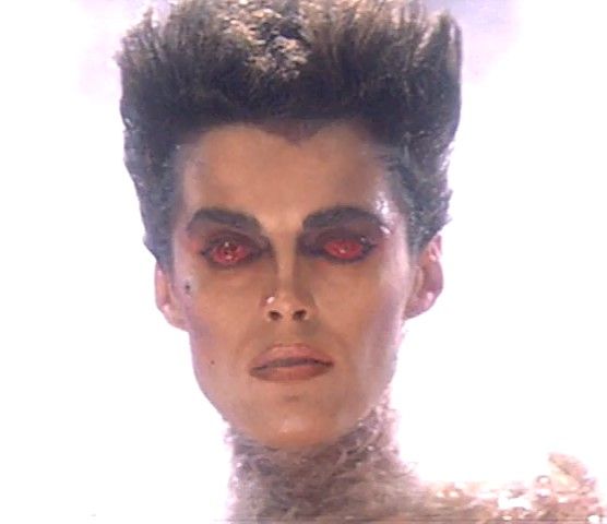 a man with red eyes and black hair is shown in an image that appears to be from the 80s