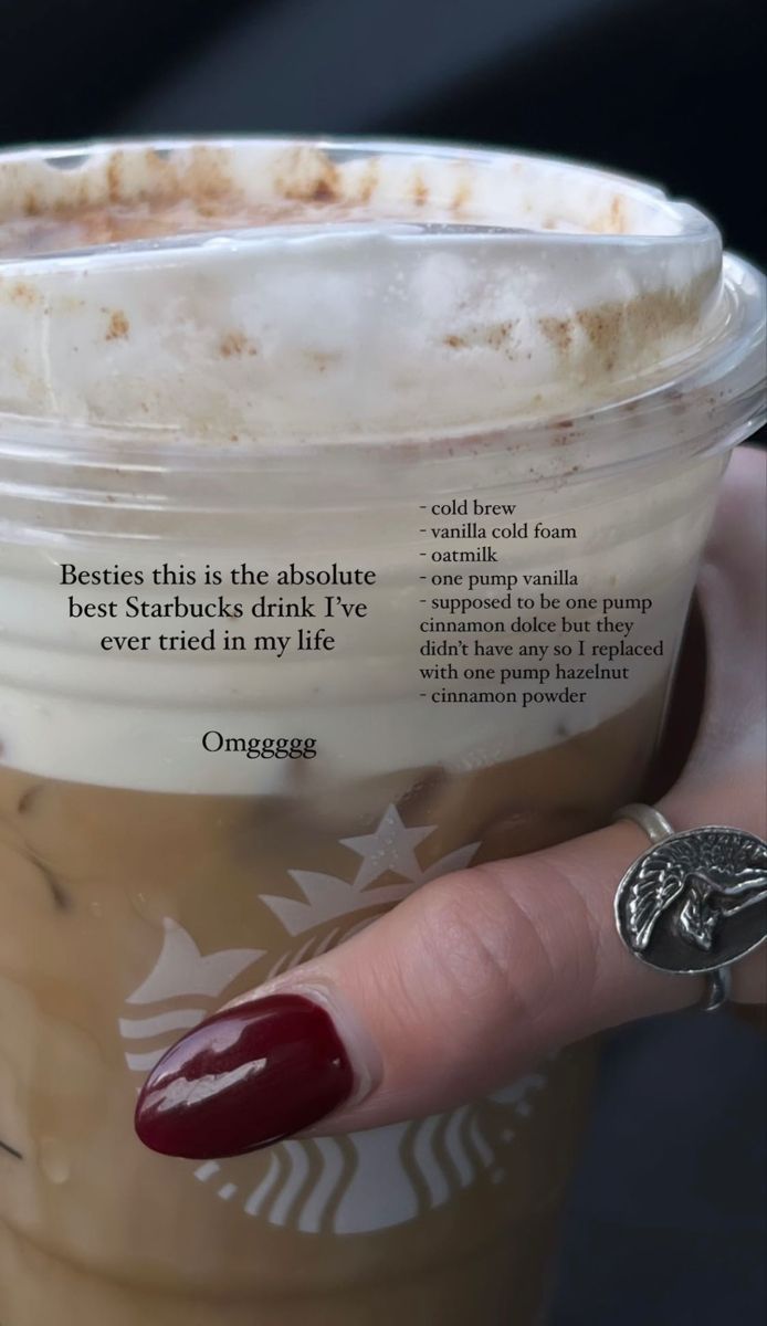 a woman's hand holding a starbucks drink