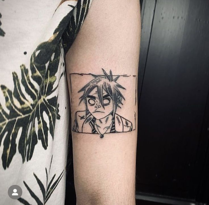 a person with a black and white tattoo on their arm is looking at the camera