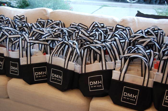 many black and white bags are lined up on a couch