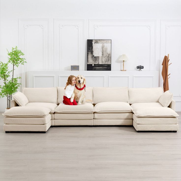 a dog sitting on top of a white couch