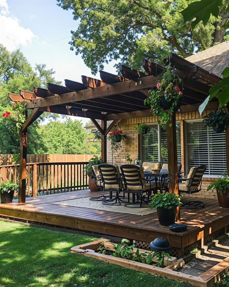 a wooden deck surrounded by potted plants and chairs under a pergolated roof