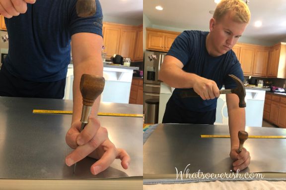 two men working on some kind of project in a kitchen