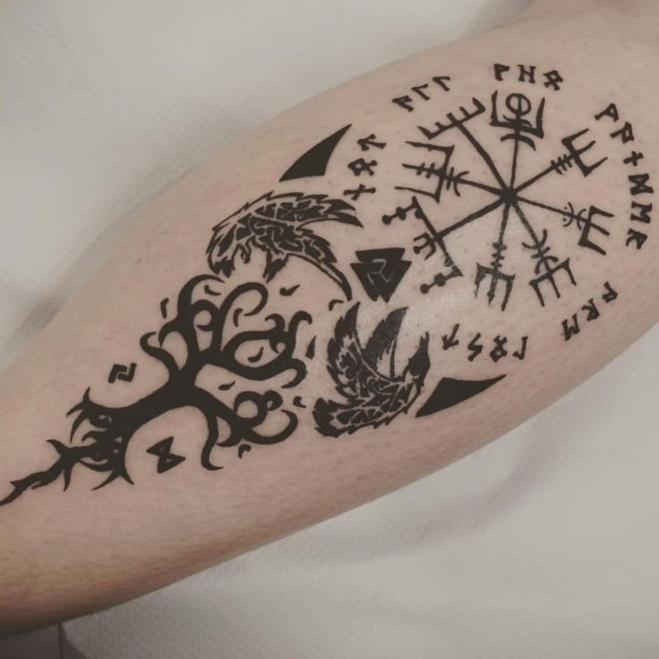 a man with a compass tattoo on his arm