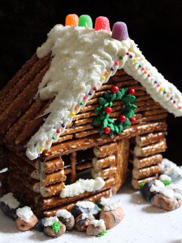 a gingerbread house made out of pretzel and icing is featured on instagram