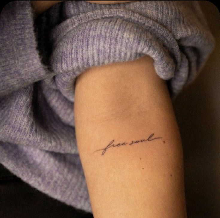 a woman's arm with a tattoo that reads, love is in the air