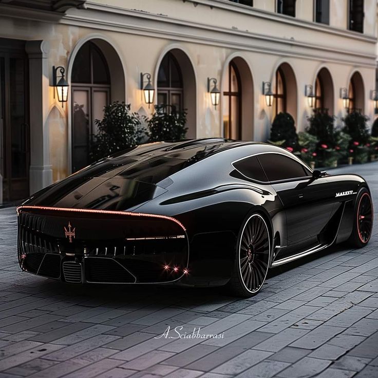 a black sports car parked on the side of a street next to a tall building